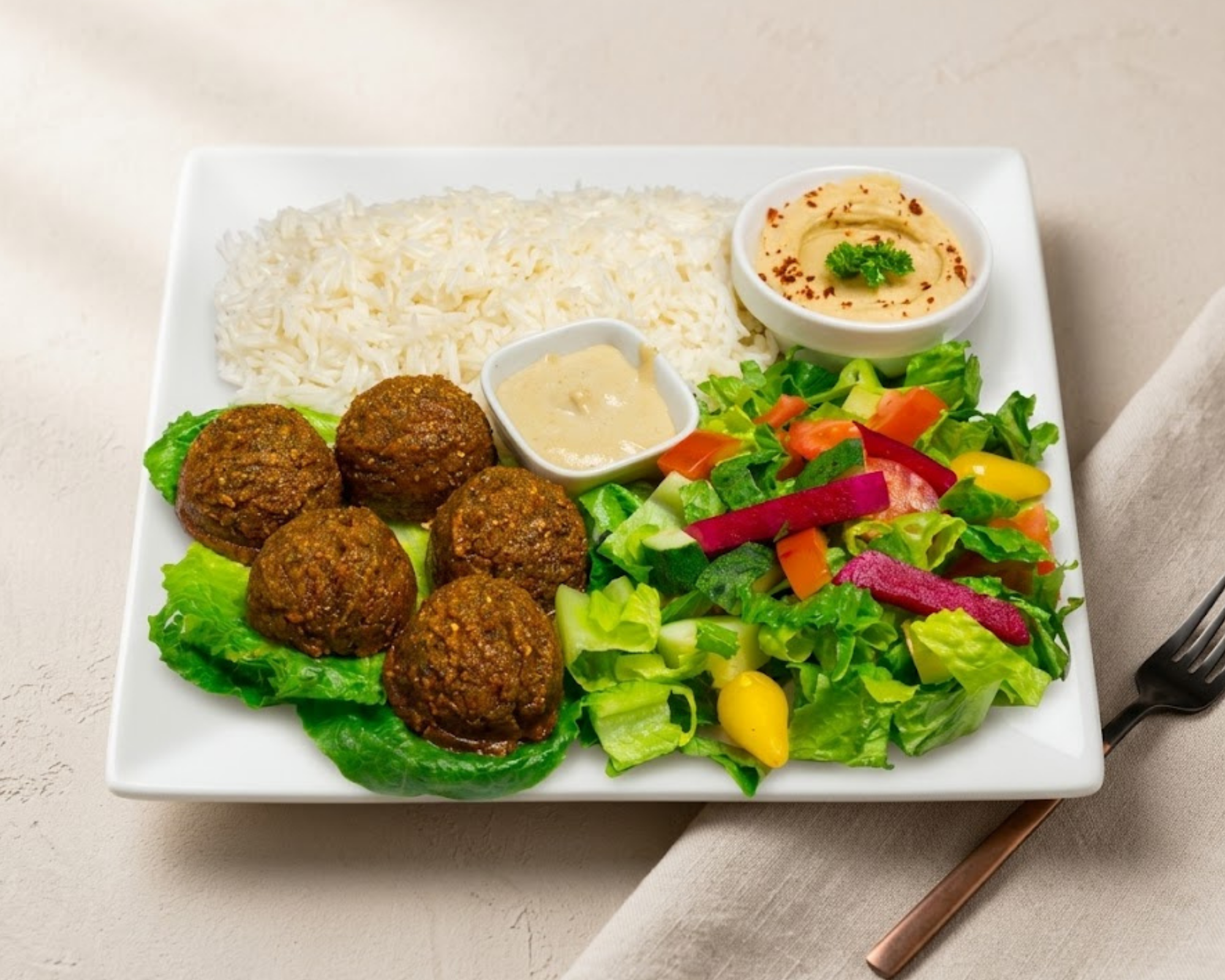 Crispy, deep-fried Mediterranean falafel from Seasoning Alley, perfect as a vegetarian appetizer or side dish.